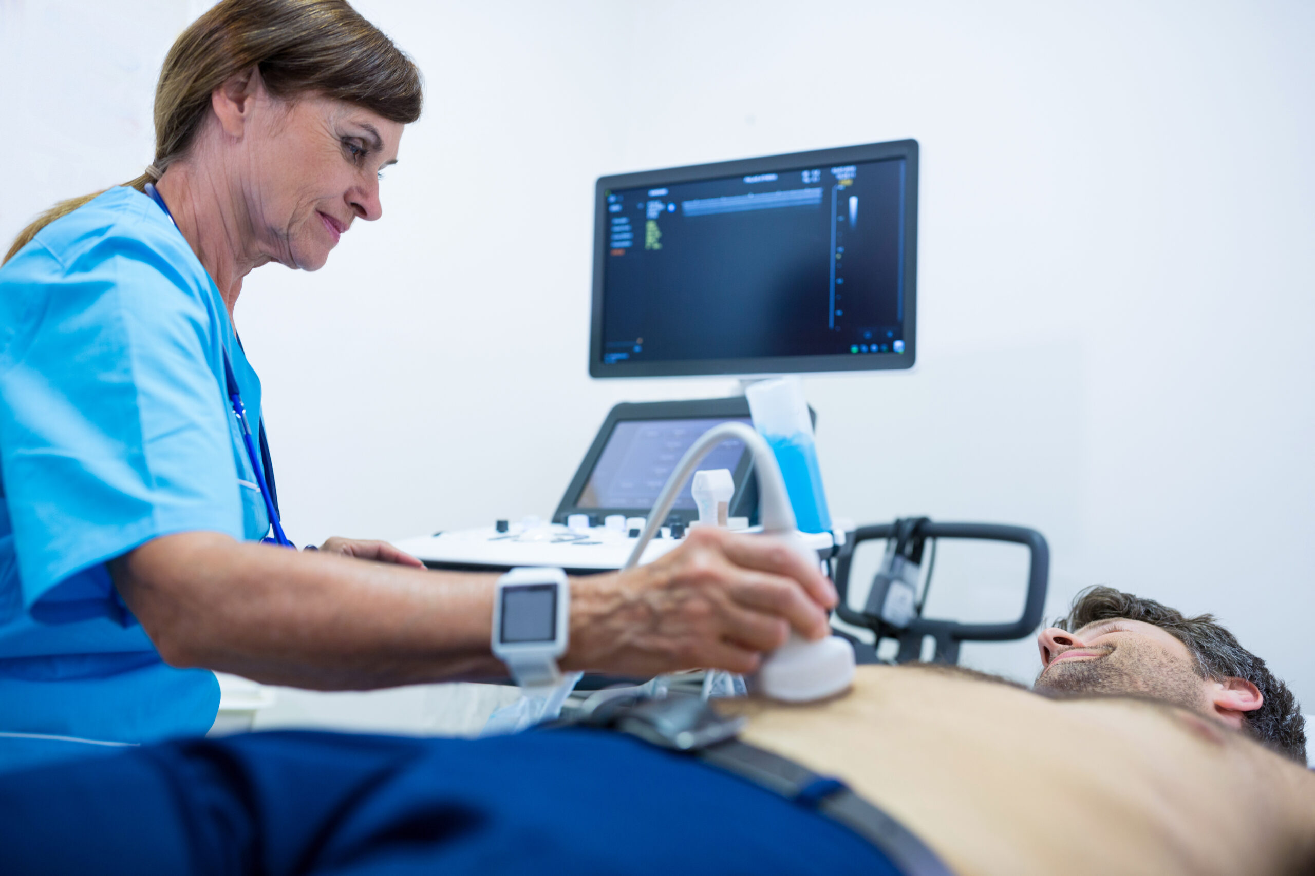 Man getting ultrasound of a abdomen from doctor in hospital